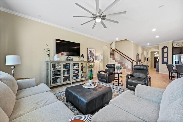 living room with light tile patterned flooring, ceiling fan, and ornamental molding