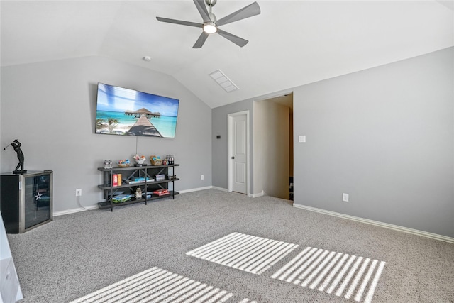 interior space featuring ceiling fan, vaulted ceiling, and carpet flooring