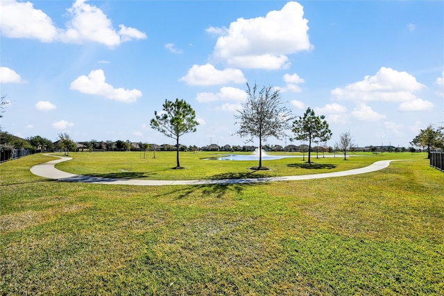 view of community with a lawn and a water view