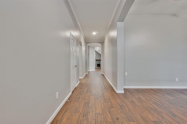 hallway featuring hardwood / wood-style flooring and crown molding