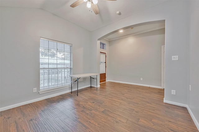 unfurnished room featuring ceiling fan, hardwood / wood-style floors, and vaulted ceiling