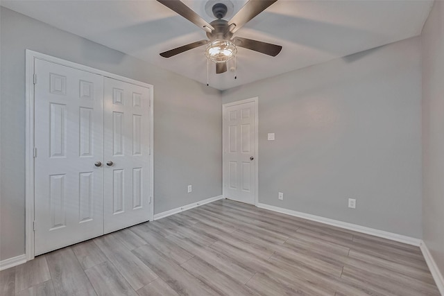 unfurnished bedroom with a closet, ceiling fan, and light hardwood / wood-style floors