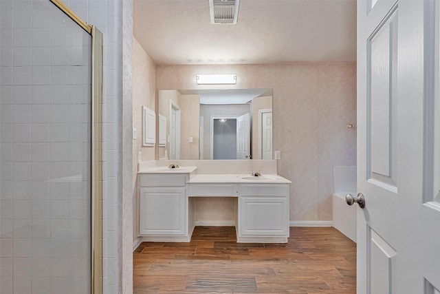 bathroom featuring vanity, walk in shower, and hardwood / wood-style floors