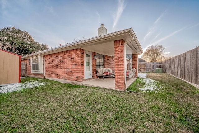 back of house featuring a patio area and a yard