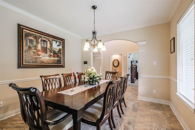 dining space featuring an inviting chandelier and crown molding