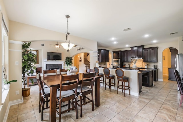 tiled dining area featuring sink and ceiling fan