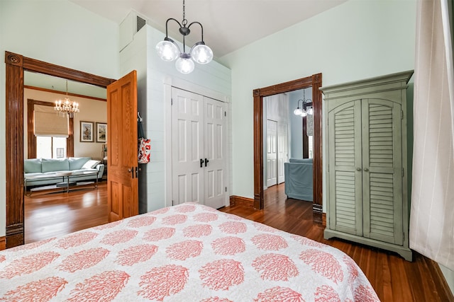 bedroom with dark wood-type flooring and a chandelier