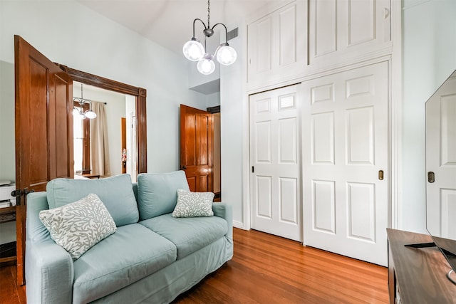 interior space with a notable chandelier and wood-type flooring