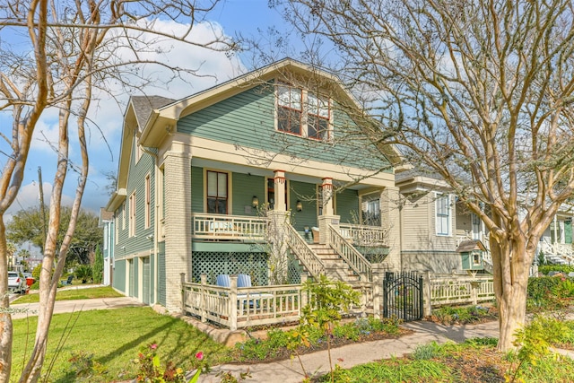 bungalow-style house featuring covered porch and a garage