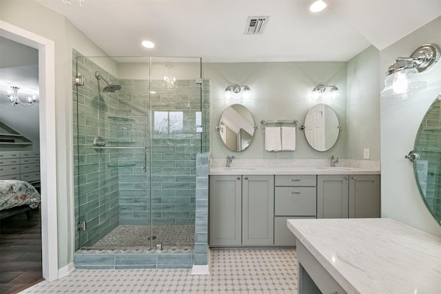 bathroom featuring vanity, a chandelier, and walk in shower