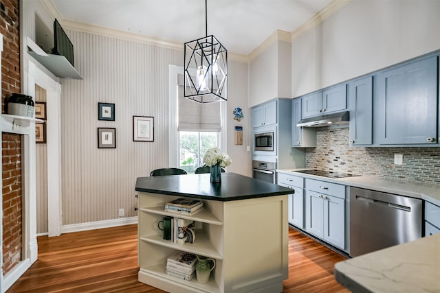 kitchen with hanging light fixtures, a kitchen island, a chandelier, crown molding, and appliances with stainless steel finishes