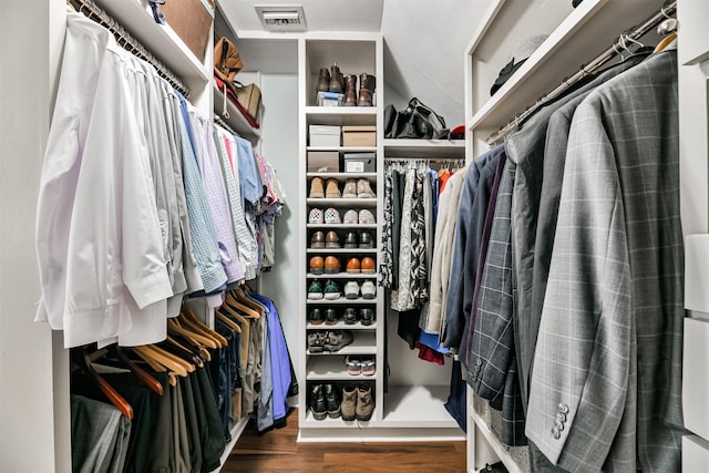 spacious closet with dark hardwood / wood-style flooring