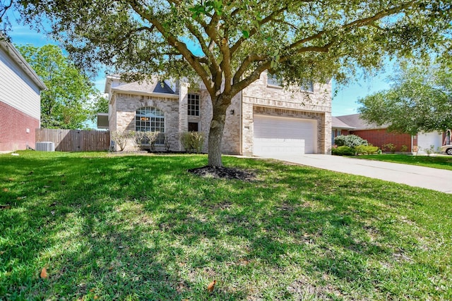 view of front of property featuring cooling unit, a front yard, and a garage