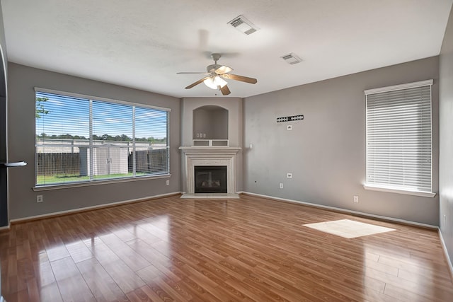 unfurnished living room with ceiling fan and hardwood / wood-style flooring