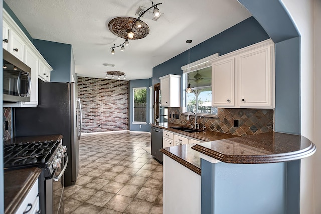 kitchen featuring sink, white cabinets, and appliances with stainless steel finishes