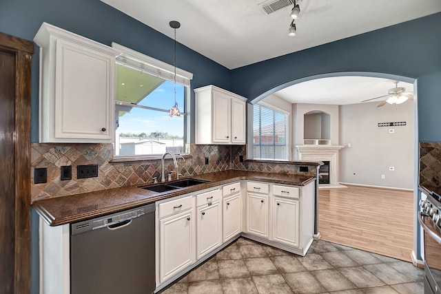 kitchen with hanging light fixtures, ceiling fan, sink, black dishwasher, and white cabinetry