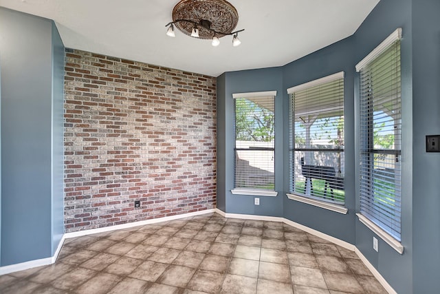 empty room featuring brick wall