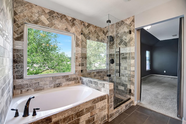 bathroom featuring shower with separate bathtub and tile patterned flooring