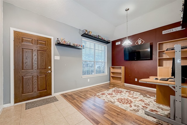 foyer with hardwood / wood-style flooring and vaulted ceiling