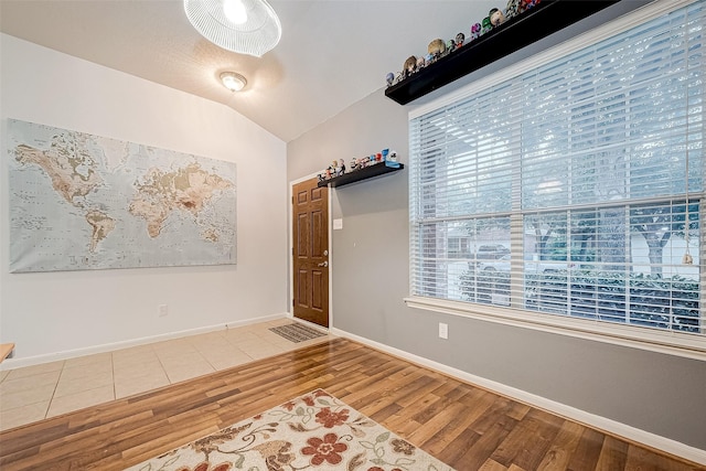 foyer with lofted ceiling and hardwood / wood-style flooring