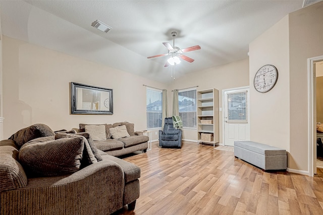 living room with light wood-type flooring and ceiling fan