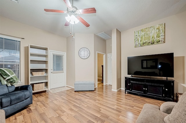 living room featuring ceiling fan and light hardwood / wood-style flooring