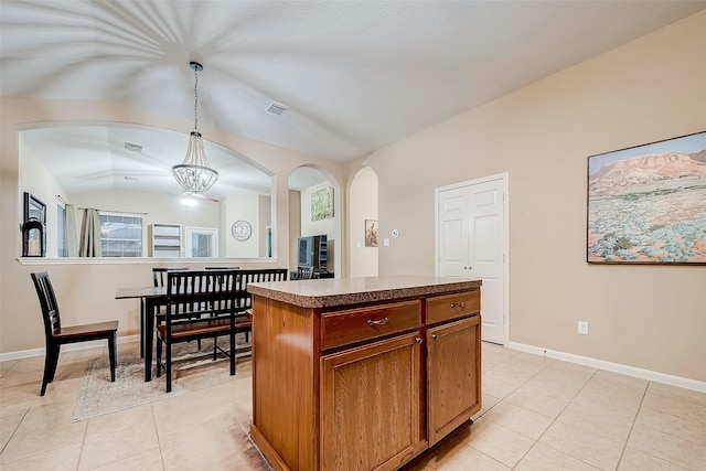 kitchen featuring a chandelier, light tile patterned floors, hanging light fixtures, and a center island