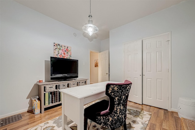 office area with light hardwood / wood-style floors