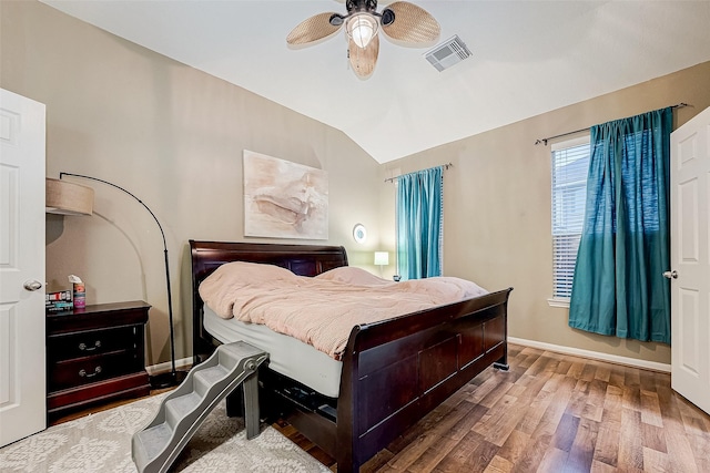 bedroom featuring hardwood / wood-style flooring, ceiling fan, and vaulted ceiling