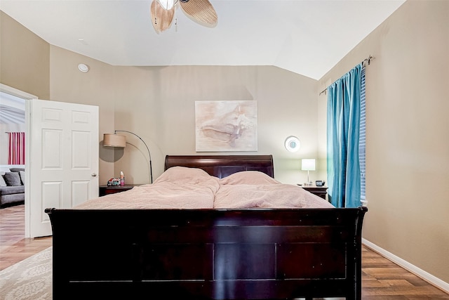 bedroom with ceiling fan, light wood-type flooring, and lofted ceiling