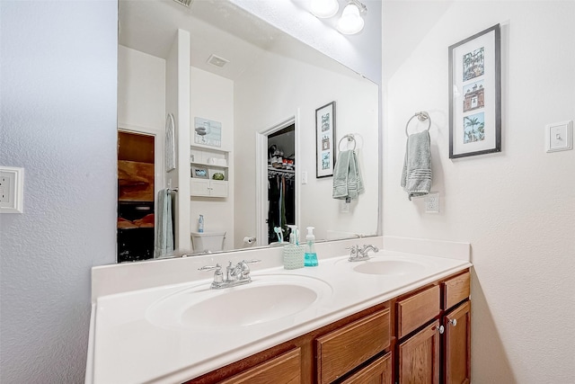 bathroom with toilet and vanity