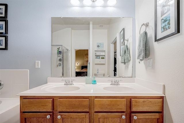 full bathroom featuring toilet, shower with separate bathtub, and vanity