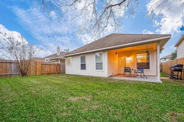 back of property with a patio and a yard