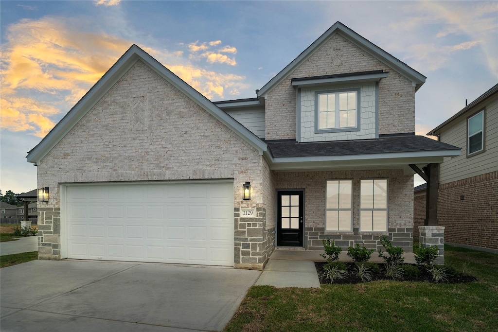 view of front of home featuring a garage and a porch