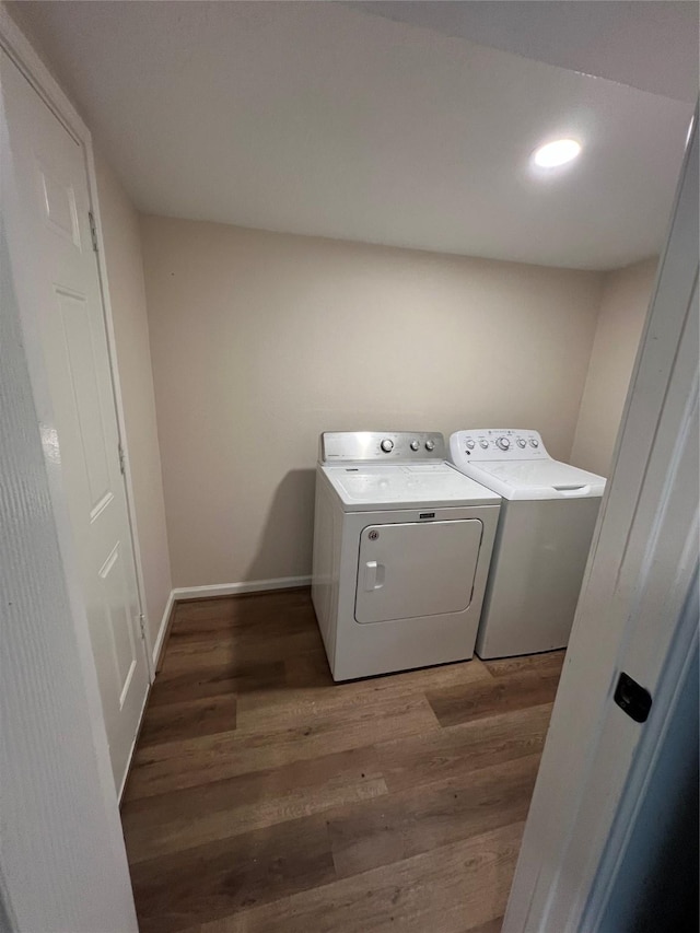 laundry area with dark hardwood / wood-style flooring and separate washer and dryer