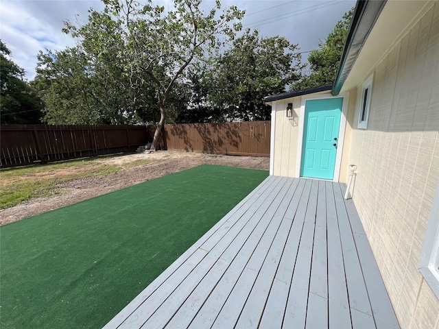 wooden terrace featuring a yard