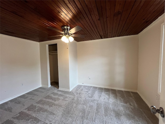 empty room with ceiling fan, wooden ceiling, and carpet