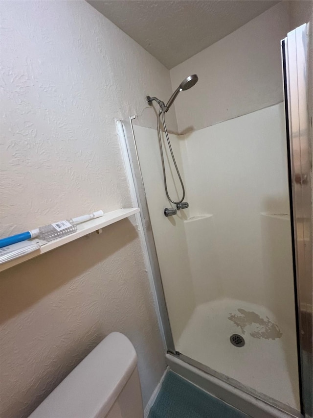 bathroom featuring a shower and toilet