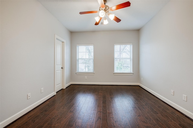 empty room featuring dark hardwood / wood-style flooring and ceiling fan