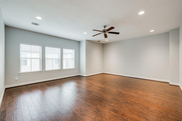 unfurnished room with ceiling fan and dark hardwood / wood-style floors