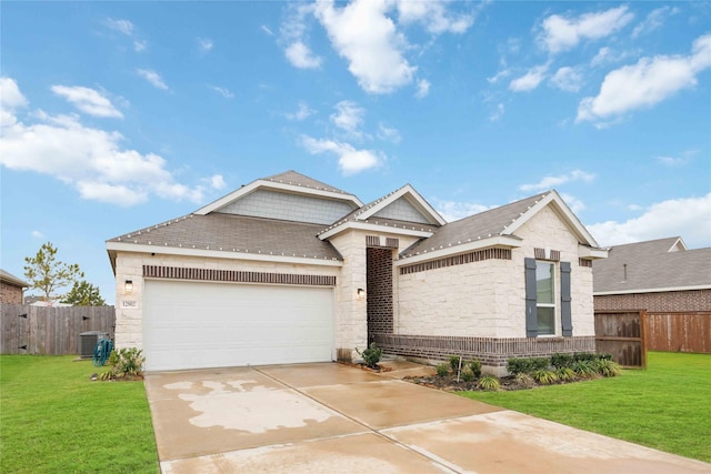 view of front of house with central AC unit, a front lawn, and a garage