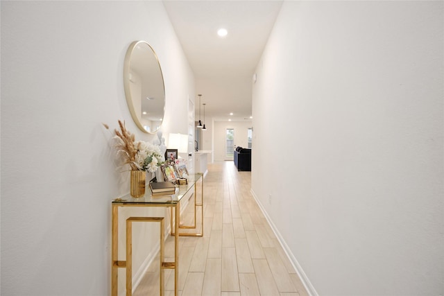 corridor with light wood-type flooring