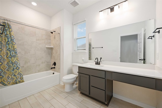 full bathroom with shower / bath combination with curtain, vanity, and toilet