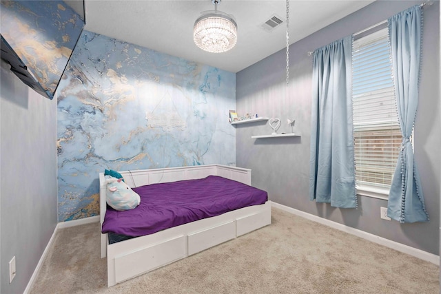 carpeted bedroom featuring a notable chandelier