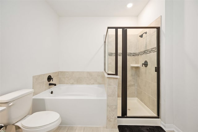 bathroom featuring shower with separate bathtub and toilet