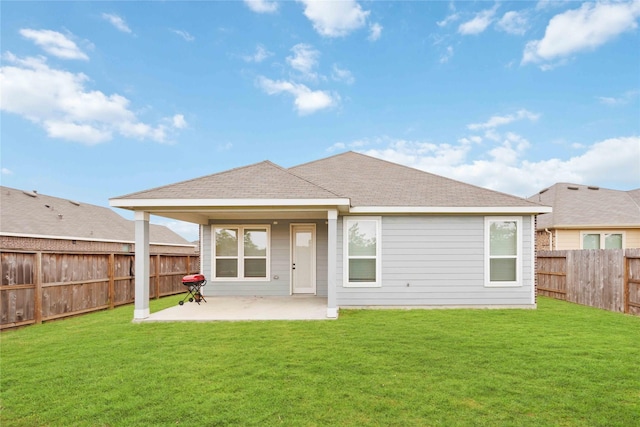 rear view of property featuring a patio and a yard