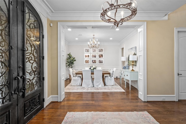 entryway featuring dark hardwood / wood-style flooring, a notable chandelier, and crown molding