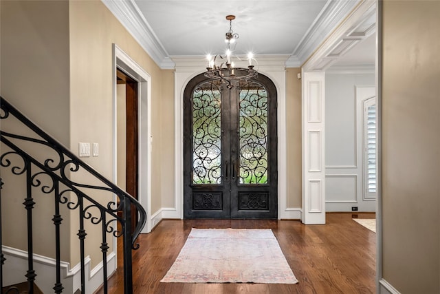 entryway featuring ornamental molding, dark hardwood / wood-style floors, and french doors