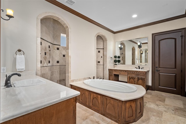 bathroom with ornamental molding, vanity, and a tub