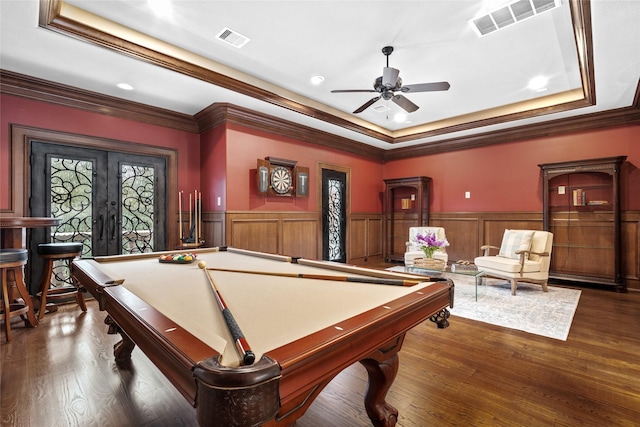 rec room with french doors, ceiling fan, dark hardwood / wood-style flooring, and a raised ceiling